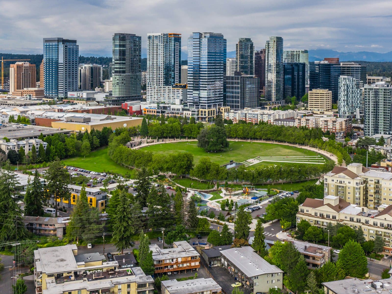 Downtown towers rising behind the lawns and trees of a large city park