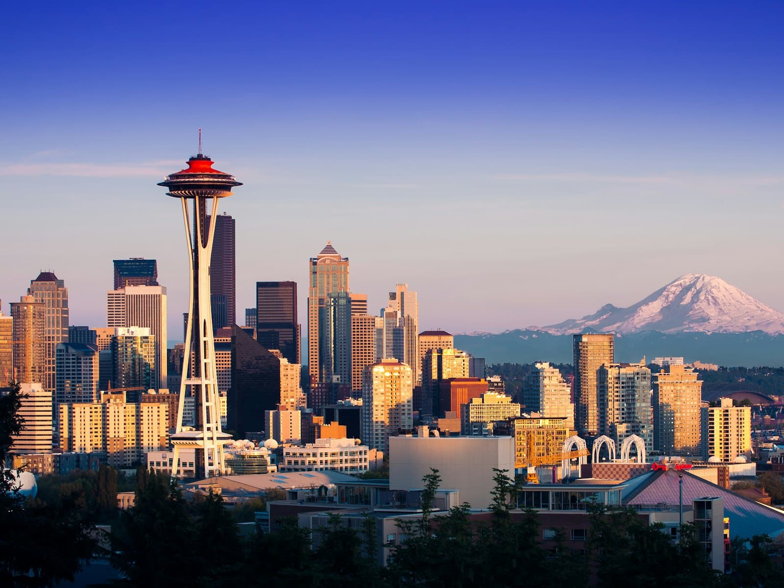 The Space Needle and downtown skyline with Mount Rainier in the distance
